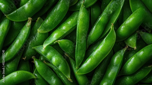 A close-up image showing a pile of fresh pea pods with their vibrant green color. This image captures the natural beauty and simplicity of fresh produce.