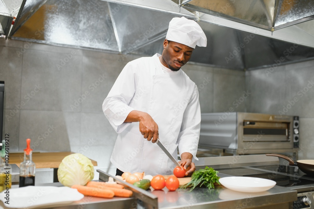 African American chef cooking tasty salad in kitchen African American chef cooking tasty salad in kitchen