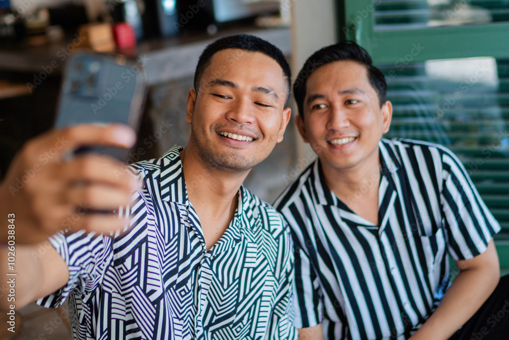 Two friends smiling while capturing a fun outdoor moment with a selfie together Two friends smiling while capturing a fun outdoor moment with a selfie together