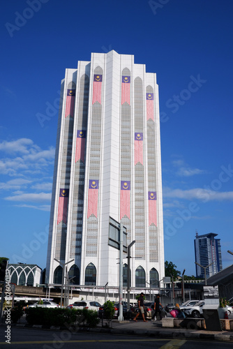 view of Dayabumi Complex or Kompleks Dayabumi under clear blue sky. one of the earliest skyscrapers and a major landmark in KL. decorated with Malaysian flags photo