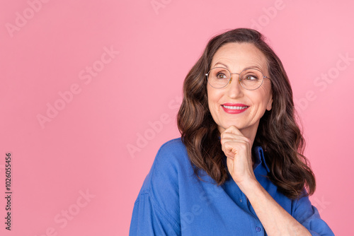 Photo portrait of attractive retired woman look thoughtful empty space dressed stylish blue clothes isolated on pink color background