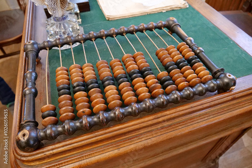 Old abacus, counting frame lies on the table in office photo