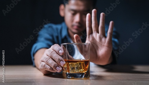 man rejecting alcohol with hand gesture photo