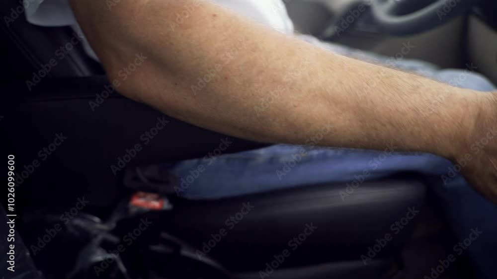 A driver confidently shifts the manual gear lever, releasing the handbrake while seated in the car. This key moment sets the stage for an exciting ride ahead. A driver confidently shifts the manual gear lever, releasing the handbrake while seated in the car. This key moment sets the stage for an exciting ride ahead.