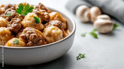 A tempting dish featuring succulent meatballs smothered in smooth creamy sauce, garnished with fresh herbs, enticingly nestled in a pristine bowl set on a rustic table.