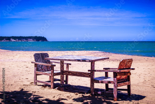 table and chairs on the beach photo