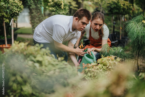 A male with Down syndrome and a female in a wheelchair work together in a greenhouse. They are engaged in gardening activities, showing teamwork and inclusivity in a lush environment. photo