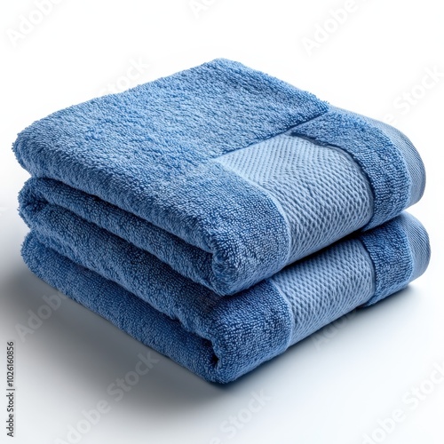 A soft cotton towel neatly folded, isolated on white background. 