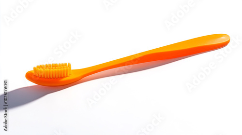 Bright orange toothbrush resting on a white background for dental hygiene use at home