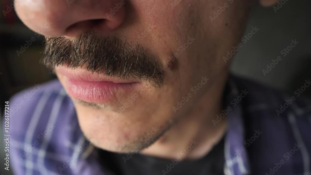 Close-up of quarrel, the mouth of angry man yells, insults the opponent. Quarrel concept. Emotions of anger. Extreme close-up mouth of angry mustachioed man screaming. Threat of violence. Close-up of quarrel, the mouth of angry man yells, insults the opponent. Quarrel concept. Emotions of anger. Extreme close-up mouth of angry mustachioed man screaming. Threat of violence.