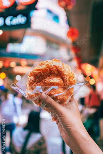 Cream puff cake on travel woman hand in Jiufen old street market