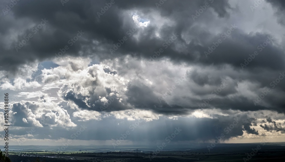 gray stormy dramatic sky with overcast and heavy textured cumulus clouds and backlight large panoramic view gray stormy dramatic sky with overcast and heavy textured cumulus clouds and backlight large panoramic view