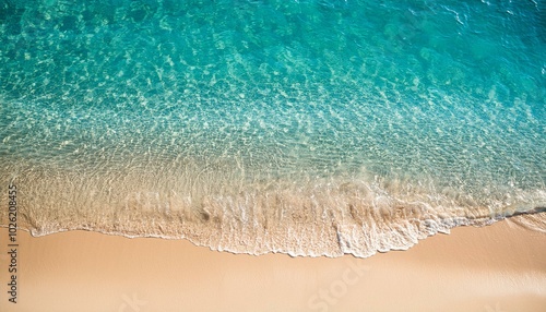 sunny abstract sand beach with transparent clear water from above natural beach background concept for vacation holiday travel and tourism with copy space closeup top view