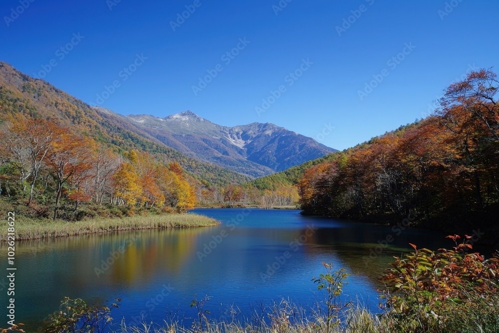 Vibrant autumn colors reflected on a serene lake surrounded by majestic mountains Vibrant autumn colors reflected on a serene lake surrounded by majestic mountains