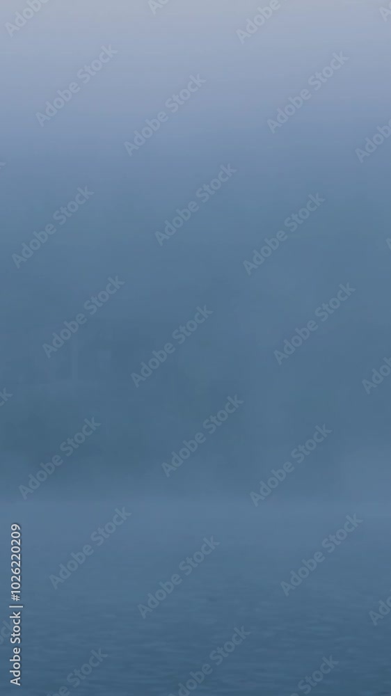 Fog slowly covering the surface of a lake Fog slowly covering the surface of a lake