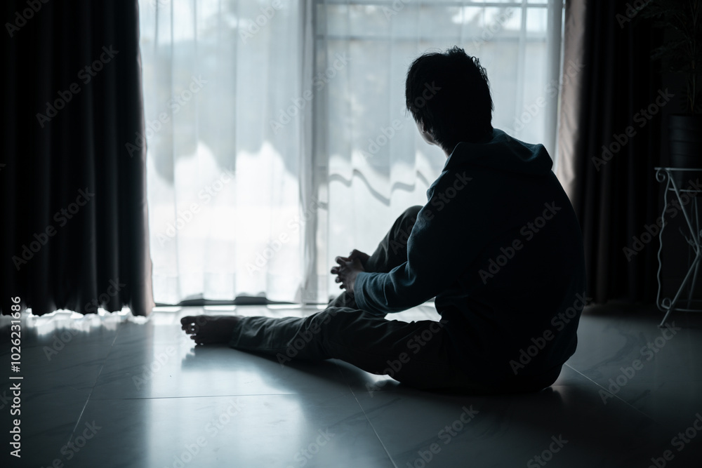 Silhouette of lost cast long shadow, embodying deep despair and hopelessness left him feeling perpetually stressed, sad, and unhappy. man sat alone, feeling weight of anxiety, stress, and depression. Silhouette of lost cast long shadow, embodying deep despair and hopelessness left him feeling perpetually stressed, sad, and unhappy. man sat alone, feeling weight of anxiety, stress, and depression.