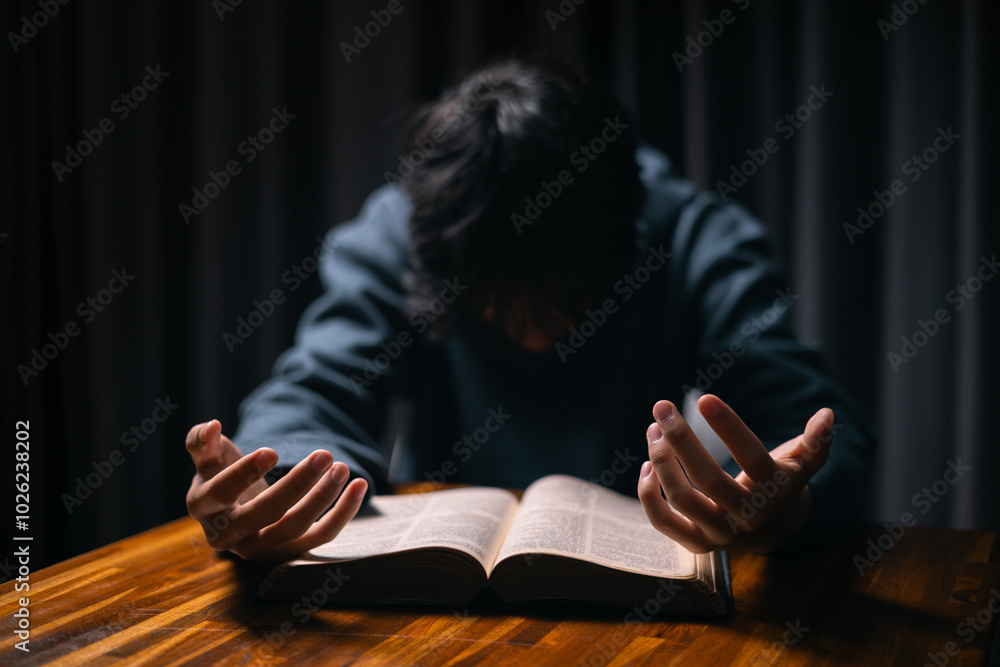 © doidam10 - Person raised their hand in prayer at the church, embodying their Christian faith and belief in God, seeking hope and the holy presence of Christ through their devout religion. jesus christ, pray.