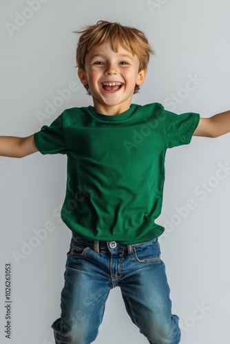 Joyful child jumping with excitement, showcasing pure happiness against a whi...