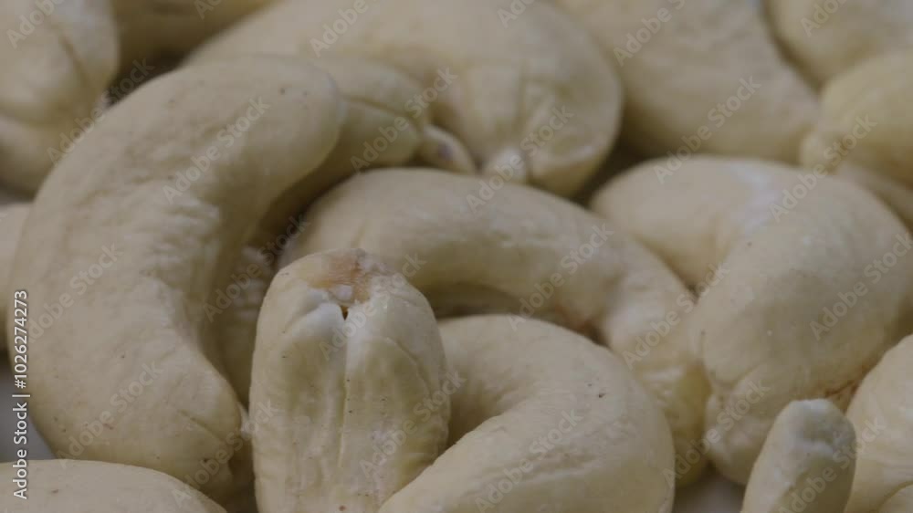 Close-up dolly left shot of a portion of raw cashew nuts, one rotten on a pile. Close-up dolly left shot of a portion of raw cashew nuts, one rotten on a pile.