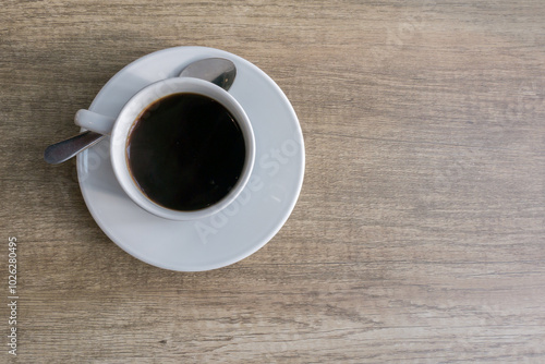 A cups of coffee on orange color wooden table background