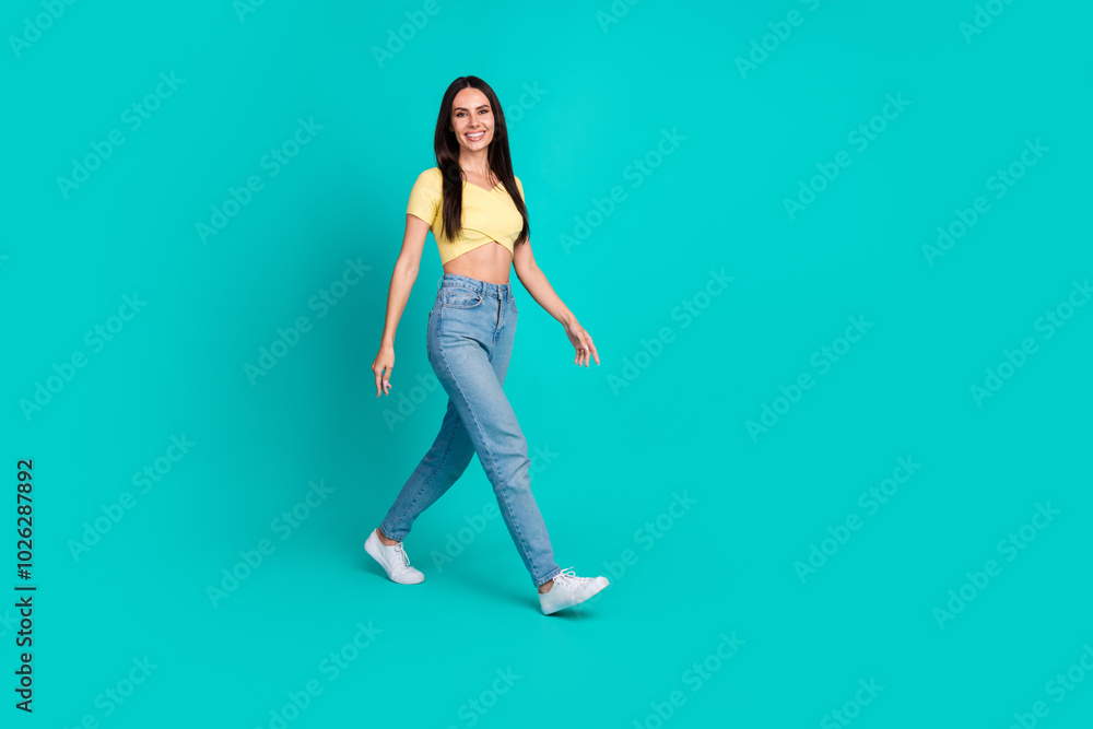 Full size profile photo of nice young woman walk empty space wear top isolated on teal color background Full size profile photo of nice young woman walk empty space wear top isolated on teal color background