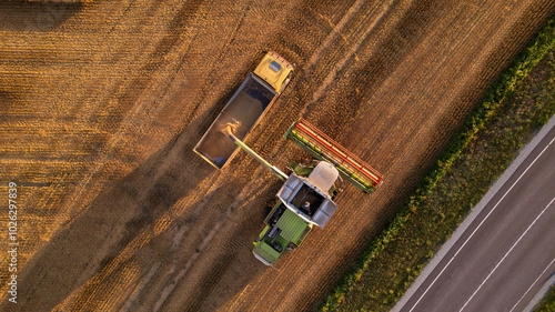 Aerial view of a combine harvester working in a field.