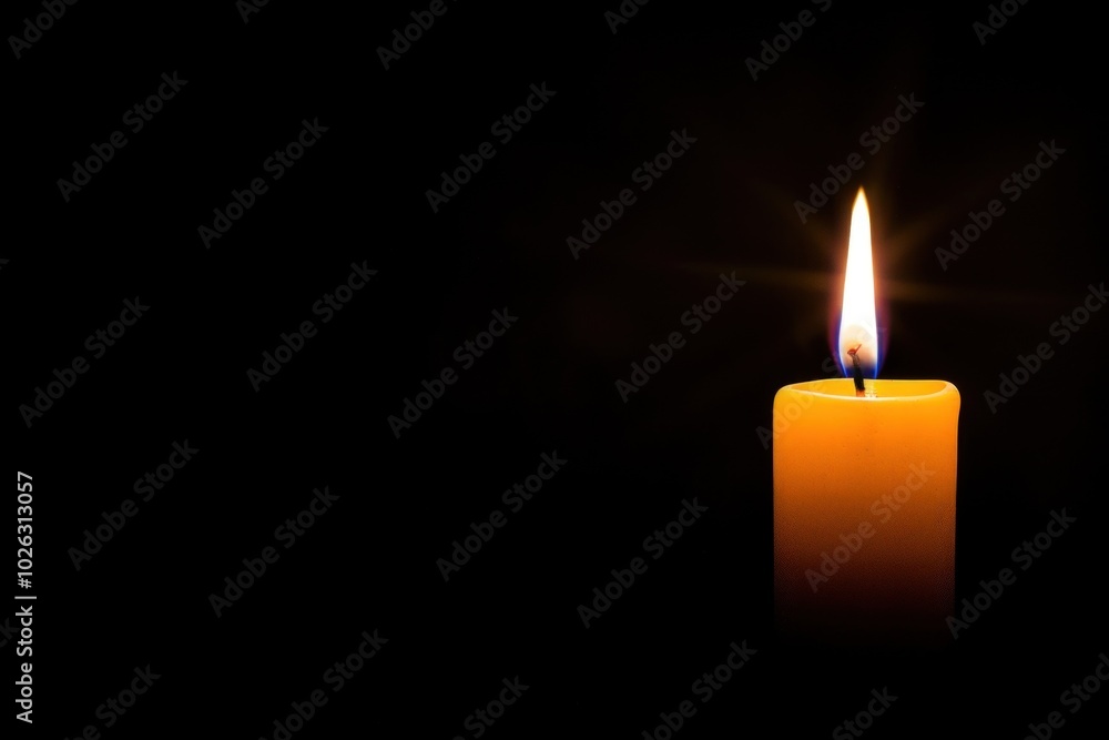 Single burning candle in dark room with warm glow and soft flickering light Single burning candle in dark room with warm glow and soft flickering light