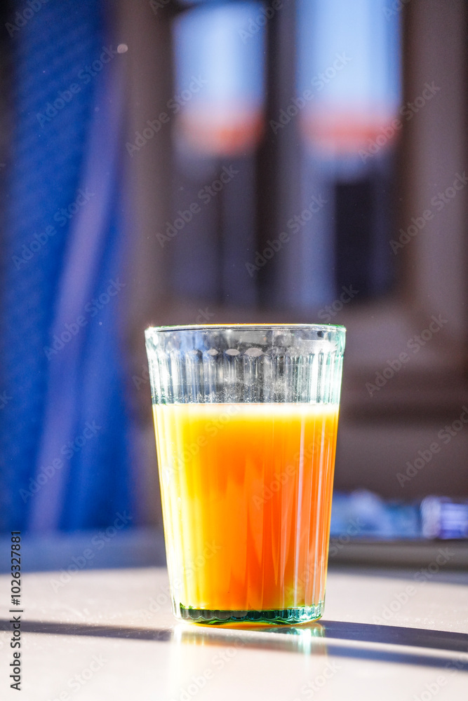Fruit juice on the breakfast table in the morning sunlight Fruit juice on the breakfast table in the morning sunlight