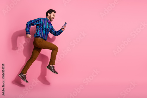 Photo of cheerful man wear stylish clothes hurrying running empty space isolated on pink color background