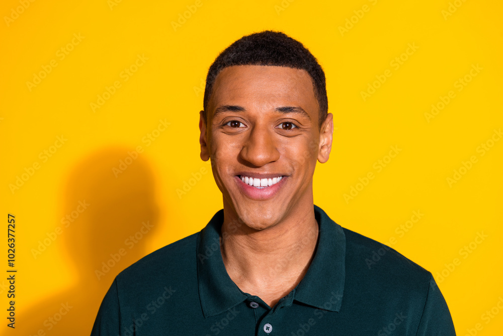 Photo of nice young man toothy smile wear pullover isolated on bright yellow color background Photo of nice young man toothy smile wear pullover isolated on bright yellow color background