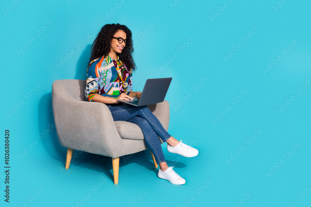 Photo of adorable lovely woman wear stylish clothes sit comfy armchair write news empty space isolated on blue color background Photo of adorable lovely woman wear stylish clothes sit comfy armchair write news empty space isolated on blue color background