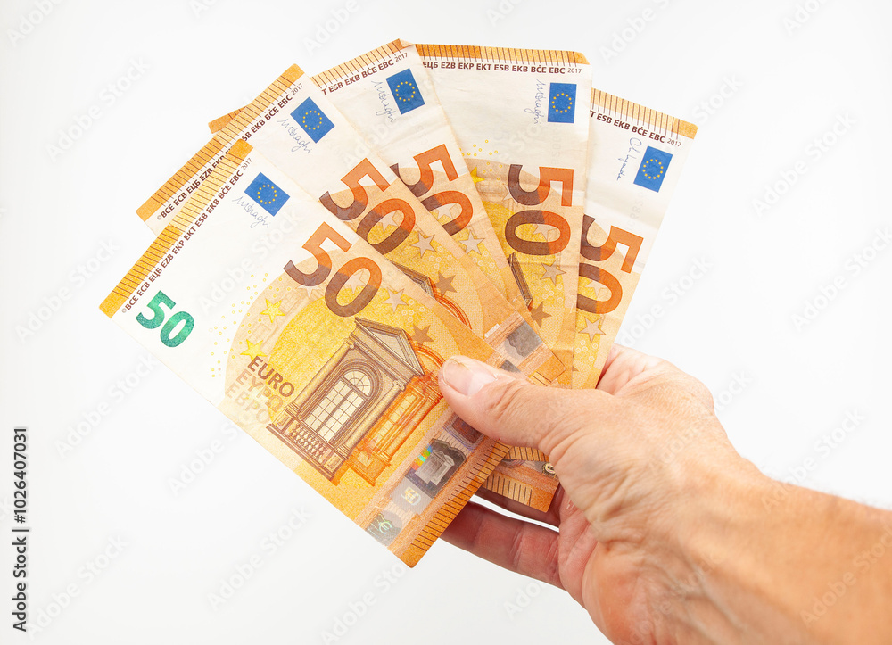 Fifty euro bills in hand on white background Fifty euro bills in hand on white background