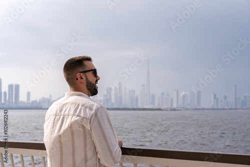 Photography Close-up of young man on a lookout point overlooking the Dubai skyline
