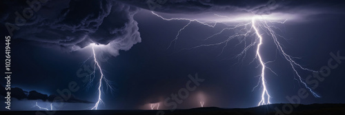 Lightning on a stormy dark cloudy background. Lightning thunderstorm flash over the night sky. Amazing lightning in the middle of a rain cloud. Powerful thunderstorm with dramatic lightning strikes 