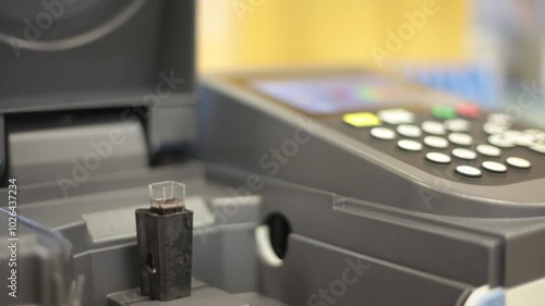 Placing a cuvette into a spectrometer to measure absorbance.