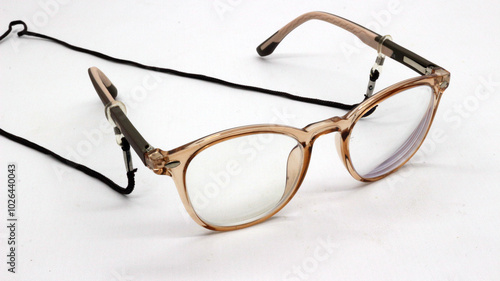 Obraz na plátně Brown glasses with black eyeglass strap