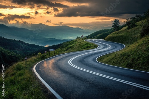 A winding mountain road at sunset with scenic views of the surrounding landscape