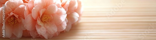 Soft pink flowers arranged on a bamboo mat, creating a serene and calming atmosphere.