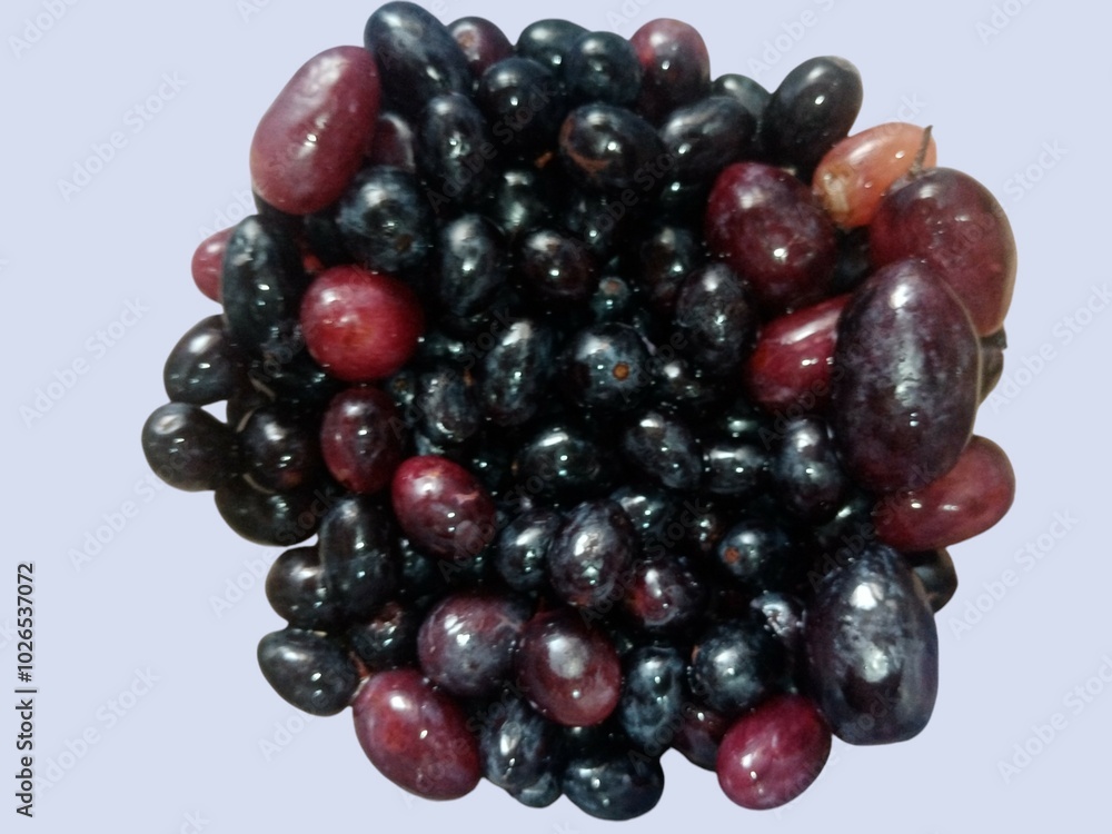 One bunch of sweet black grapes in isolated on sky blue background. One bunch of sweet black grapes in isolated on sky blue background.