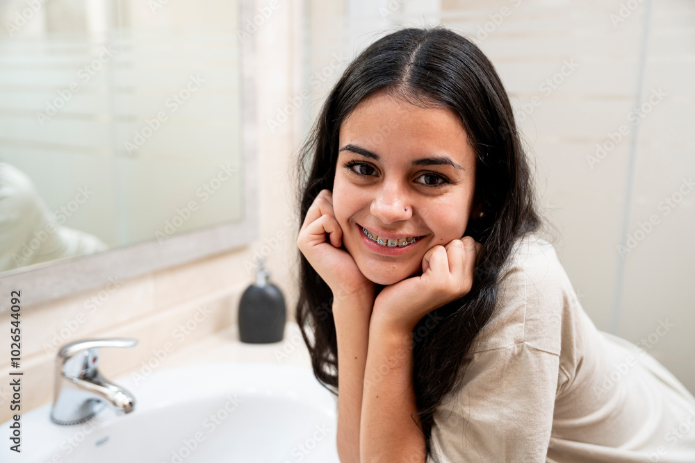 Teen brunette with braces smiling confidently Teen brunette with braces smiling confidently