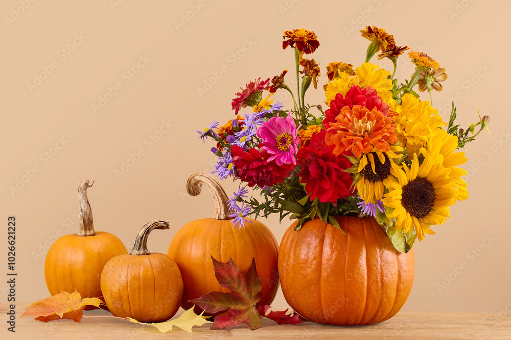 Autumn Pumpkin Bouquet. A vibrant bouquet of autumn flowers in a carved pumpkin vase Autumn Pumpkin Bouquet. A vibrant bouquet of autumn flowers in a carved pumpkin vase