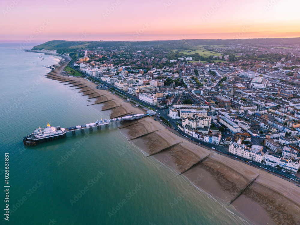 Aerial of Eastbourne cityscape with pier during sunset East Sussex England