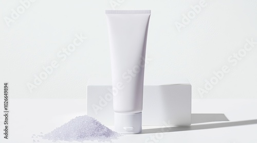 Facial scrub tube with exfoliating beads visible inside, slightly squeezed to reveal the product, placed on a white background