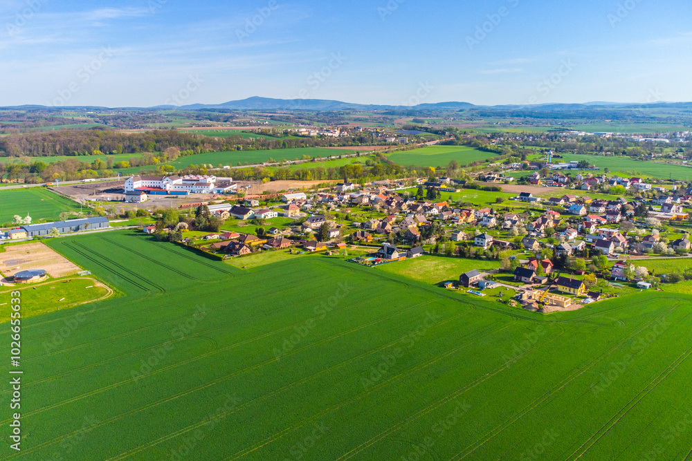 A birds-eye view captures Doubrava Village near Turnov, showcasing its landscape, houses, fields, and roads against the backdrop of a clear sky. Czechia A birds-eye view captures Doubrava Village near Turnov, showcasing its landscape, houses, fields, and roads against the backdrop of a clear sky. Czechia