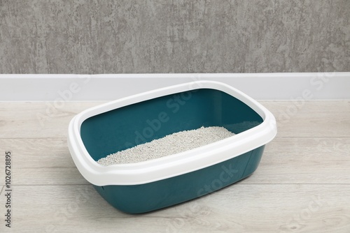 Cat tray with clumping litter on floor indoors photo