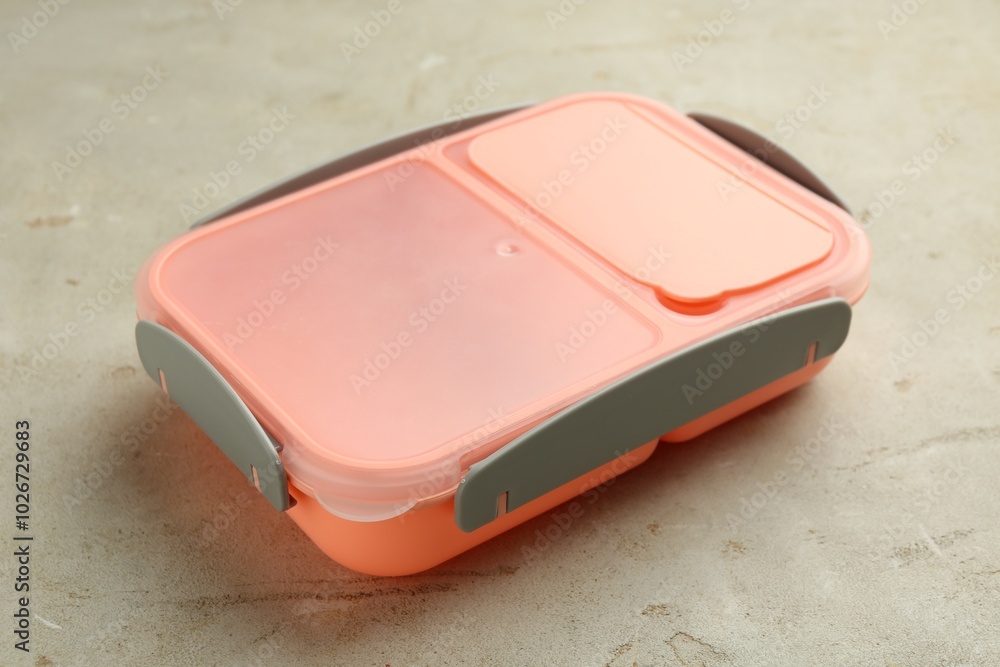 One plastic lunch box on grey table, closeup One plastic lunch box on grey table, closeup