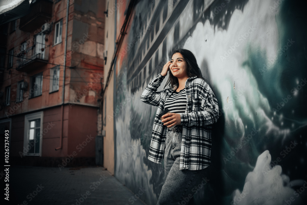 Stylish Brunette by the Graffiti Wall in the Evening Stylish Brunette by the Graffiti Wall in the Evening