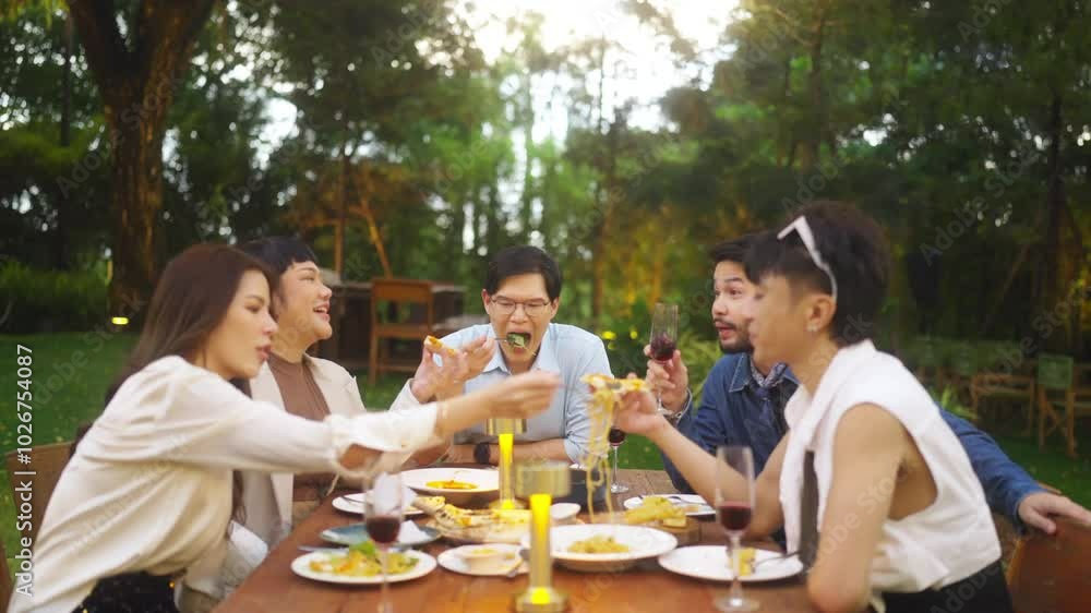 Group of Happy Asian millennial generation people friends enjoy and fun celebration reunion meeting outdoor dinner party with food and drink together in the garden at restaurant on holiday vacation. Group of Happy Asian millennial generation people friends enjoy and fun celebration reunion meeting outdoor dinner party with food and drink together in the garden at restaurant on holiday vacation.