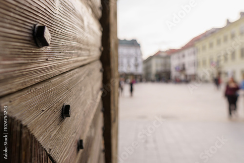 Photography Old wooden gate and detail of its riveting, blurred castle in the background, Sl