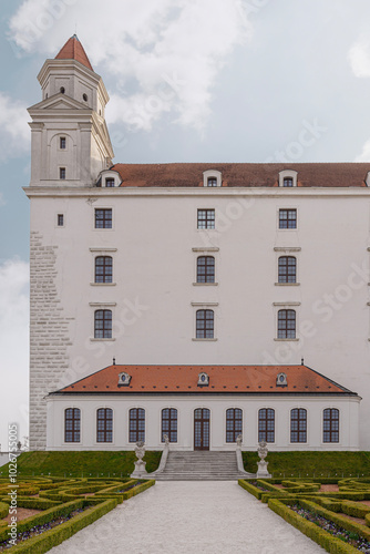 Photography Detail of castle building with one of the towers and windows, in sunlight, Slova